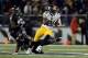 BALTIMORE, MD - NOVEMBER 28: Le'Veon Bell #26 of the Pittsburgh Steelers avoids the tackle of Terrell Suggs #55 of the Baltimore Ravens in the second half of an NFL game at M&T Bank Stadium on November 28, 2013 in Baltimore, Maryland. (Photo by Patrick
