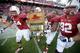 PALO ALTO, CA - NOVEMBER 23: David Yankey #54, Shayne Skov #11 and Khalil Wilkes #65 and Dillon Bonnell #92 of the Stanford Cardinal run onto the field with the Axe after they retained it for beating the California Golden Bears of the Stanford Cardinalat
