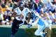 CHAPEL HILL, NC - NOVEMBER 30: Anthony Boone #7 of the Duke Blue Devils rolls ut under pressure from Jeff Schoettmer #34 of the North Carolina Tar Heels during play at Kenan Stadium on November 30, 2013 in Chapel Hill, North Carolina. (Photo by Grant Ha