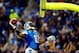 Nov 28, 2013; Detroit, MI, USA; Detroit Lions wide receiver Calvin Johnson (81) dunks the football over the goal post after scoring a touchdown during the third quarter of a NFL football game against the Green Bay Packers on Thanksgiving at Ford Field. Ma