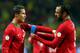 STOCKHOLM, SWEDEN - NOVEMBER 19: Huga Almeida helps Cristiano Ronaldo of Portugal with his captains bandage runs with the ball during the FIFA 2014 World Cup Qualifier Play-off Second Leg match between Sweden and Portugal at Friends Arena on November 19,