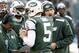 EAST RUTHERFORD, NJ - DECEMBER 1: Geno Smith #7, Matt Simms #5 and Mark Sanchez #6 of the New York Jets stand with New York Jets offensive coordinator Marty Mornhinweg during their game against the Miami Dolphins at MetLife Stadium on December 1, 2013 i
