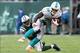 Dec 1, 2013; East Rutherford, NJ, USA; Miami Dolphins running back Lamar Miller (26) breaks a tackle by New York Jets corner back Dee Milliner (27) during the third quarter of a game at MetLife Stadium. The Dolphins defeated the Jets 23-3. Mandatory Credi