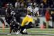 BALTIMORE, MD - NOVEMBER 28: Le'Veon Bell #26 of the Pittsburgh Steelers avoids the tackle of Terrell Suggs #55 of the Baltimore Ravens in the second half of an NFL game at M&T Bank Stadium on November 28, 2013 in Baltimore, Maryland. (Photo by Patrick