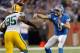 DETROIT, MI - NOVEMBER 28: Matthew Stafford #9 of the Detroit Lions throws a third quarter touchdown pass behind the rush of Datone Jones #95 of the Green Bay Packers at Ford Field on November 28, 2013 in Detroit, Michigan. (Photo by Gregory Shamus/Getty