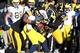 Nov 23, 2013; Iowa City, IA, USA; Michigan Wolverines quarterback Devin Gardner (98) is sacked by Iowa Hawkeyes linebacker Christian Kirksey (20) and left tackle Carl Davis (71) at Kinnick Stadium. Iowa beat Michigan 24-21. Mandatory Credit: Reese Strick