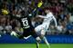 MADRID, SPAIN - SEPTEMBER 28: Alvaro Morata of Real Madrid CF strikes the ball past goalkeeper Thibaut Courtois of Atletico de Madrid during the La Liga match between Real Madrid CF and Club Atletico de Madrid at Estadio Santiago Bernabeu on September 28,