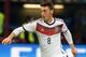MILAN, ITALY - NOVEMBER 15: Mesut Ozil of Germany in action during the international friendly match between Italy and Germany at Giuseppe Meazza stadium on November 15, 2013 in Milan, Italy. (Photo by Claudio Villa/Getty Images)