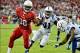 Nov 24, 2013; Phoenix, AZ, USA; Arizona Cardinals running back Andre Ellington (38) fends off a tackle from Indianapolis Colts strong safety Antoine Bethea (41) and cornerback Cassius Vaughn (32) during the first half at University of Phoenix Stadium. Man