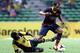 KUALA LUMPUR, MALAYSIA - AUGUST 10: Martin Montoya of Barcelona FC is tackled by S. Kunanalan of Malaysia during the friendly match between FC Barcelona and Malaysia at the Shah Alam Stadium on August 10, 2013 in Kuala Lumpur, Malaysia. (Photo by Stanle