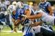 Dec 1, 2013; Indianapolis, IN, USA; Indianapolis Colts quarterback Andrew Luck (12) loses the ball after being hit by Tennessee Titans defensive end Derrick Morgan (91) in the first half at Lucas Oil Stadium. Mandatory Credit: Thomas J. Russo-USA TODAY Sp