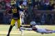 ANN ARBOR, MI - NOVEMBER 30: Quarterback Devin Gardner #98 of the Michigan Wolverines avoids a tackle by cornerback Bradley Roby #1 of the Ohio State Buckeyes during a game at Michigan Stadium on November 30, 2013 in Ann Arbor, Michigan. (Photo by Grego