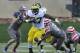Nov 16, 2013; Evanston, IL, USA; Michigan Wolverines running back Derrick Green (27) runs with the ball as Northwestern Wildcats safety Traveon Henry (10) tackles during the first half at Ryan Field. Mandatory Credit: David Banks-USA TODAY Sports