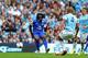 MANCHESTER, ENGLAND - OCTOBER 05: Romelu Lukaku of Everton scores the opening goal as Vincent Kompany of Manchester City closes in during the Barclays Premier League match between Manchester City and Everton at Etihad Stadium on October 5, 2013 in Manche
