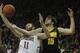 IOWA CITY, IA - DECEMBER 3: Forward Zach McCabe #15 of the Iowa Hawkeyes battles for a rebound during the first half against center Garrick Sherman #11 of the Notre Dame Fighting Irish on December 3, 2013 at Carver-Hawkeye Arena in Iowa City, Iowa. (Phot