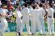 DUNEDIN, NEW ZEALAND - DECEMBER 04: New Zealand players rush to congratulate Trent Boult after claiming a West Indies wicket during day two of the first test match between New Zealand and the West Indies at University Oval on December 4, 2013 in Dunedin,
