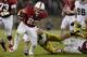 PALO ALTO, CA - NOVEMBER 30: Tyler Gaffney #25 of the Stanford Cardinal breaks the tackle of Carlo Calabrese #44 of the Notre Dame Fighting Irish and rushes for eight yards during the third quarter at Stanford Stadium on November 30, 2013 in Palo Alto, C