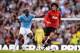 MANCHESTER, ENGLAND - SEPTEMBER 22: Marouane Fellaini of Manchester United evades Yaya Toure of Manchester City during the Barclays Premier League match between Manchester City and Manchester United at the Etihad Stadium on September 22, 2013 in Manchest