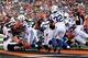 Aug 29, 2013; Cincinnati, OH, USA; Cincinnati Bengals running back Giovani Bernard (25) scores a touchdown as Indianapolis Colts linebacker Mario Harvery (54) tries to make a tackle at the goal line at Paul Brown Stadium. Mandatory Credit: Brian Spurlock-