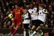 LIVERPOOL, ENGLAND - DECEMBER 4: Luis Suarez of Liverpool controls the ball from Ryan Bennett and Leroy Fer of Norwich City for his third goal during the Barclays Premier League match between Liverpool and Norwich City at Anfield on December 4, 2013 in