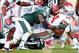 September 29, 2012; East Lansing, MI, USA; Ohio State Buckeyes running back Carlos Hyde (34) is tackled by Michigan State Spartans linebacker Chris Norman (10) and defensive end William Gholston (2) during the second half of a game at Spartan Stadium. Ohi