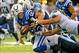 Dec 1, 2013; Indianapolis, IN, USA; Indianapolis Colts quarterback Andrew Luck (12) loses the ball after being hit by Tennessee Titans defensive end Derrick Morgan (91) in the first half at Lucas Oil Stadium. Mandatory Credit: Thomas J. Russo-USA TODAY Sp