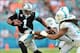 Nov 24, 2013; Miami Gardens, FL, USA; Carolina Panthers quarterback Cam Newton (1) is tackled by Miami Dolphins defensive end Cameron Wake (91) during the second half at Sun Life Stadium. The Panthers won 20-16. Mandatory Credit: Steve Mitchell-USA TODAY