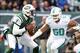 Dec 1, 2013; East Rutherford, NJ, USA; New York Jets quarterback Geno Smith (7) is pressured by Miami Dolphins defensive end Olivier Vernon (50) during the first quarter of a game at MetLife Stadium. Mandatory Credit: Brad Penner-USA TODAY Sports