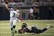 September 30, 2012; St. Louis, MO, USA; Seattle Seahawks quarterback Russell Wilson (3) attempts a pass as St. Louis Rams defensive tackle Michael Brockers (90) attempts the tackle during the first half at the Edward Jones Dome. Mandatory Credit: Photo by