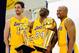 EL SEGUNDO, CA - SEPTEMBER 25: Kobe Bryant #24 of the Los Angeles Lakers laughs as he holds two NBA Finals Larry O'Brien Championship Trophy's as he poses for a photograph with teammates Pau Gasol #16 and Derek Fisher #2 during Media Day at the Toyota C