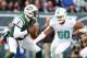 Dec 1, 2013; East Rutherford, NJ, USA; New York Jets quarterback Geno Smith (7) is pressured by Miami Dolphins defensive end Olivier Vernon (50) during the first quarter of a game at MetLife Stadium. Mandatory Credit: Brad Penner-USA TODAY Sports