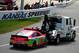 KANSAS CITY, KS - OCTOBER 06: The #10 GoDaddy Chevrolet of Danica Patrick is towed to the garage after an on-track incident on the first lap of the NASCAR Sprint Cup Series 13th Annual Hollywood Casino 400 at Kansas Speedway on October 6, 2013 in Kansas