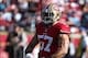 Nov 10, 2013; San Francisco, CA, USA; San Francisco 49ers inside linebacker Michael Wilhoite (57) flexes his muscles after a tackle on a punt return against the Carolina Panthers during the first quarter at Candlestick Park. Mandatory Credit: Kelley L Cox