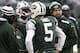 EAST RUTHERFORD, NJ - DECEMBER 1: Geno Smith #7, Matt Simms #5 and Mark Sanchez #6 of the New York Jets stand with New York Jets offensive coordinator Marty Mornhinweg during their game against the Miami Dolphins at MetLife Stadium on December 1, 2013 in