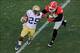 Nov 30, 2013; Atlanta, GA, USA; Georgia Tech Yellow Jackets running back Robert Godhigh (25) runs against Georgia Bulldogs linebacker Leonard Floyd (84) during the second quarter at Bobby Dodd Stadium. Mandatory Credit: Dale Zanine-USA TODAY Sports