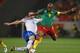CAPE TOWN, SOUTH AFRICA - JUNE 24: Samuel Eto'o of Cameroon is tackled by Mark Van Bommel during the 2010 FIFA World Cup South Africa Group E match between Cameroon and Netherlands at Green Point Stadium on June 24, 2010 in Cape Town, South Africa. (Pho