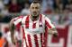 ATHENS, GREECE - SEPTEMBER 17: Kostas Mitroglou of Olympiacos FC in action during the UEFA Champions League group stage match between Olympiacos FC and Paris Saint-Germain FC held on September 17, 2013 at the Georgios Karaiskakis Stadium in Athens, Greec