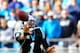 CHARLOTTE, NC - DECEMBER 01: Cam Newton #1 of the Carolina Panthers flips a shovel pass to a teammate before being sacked by William Gholston #92 of the Tampa Bay Buccaneers during play at Bank of America Stadium on December 1, 2013 in Charlotte, North C