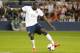 KANSAS CITY, KS - OCTOBER 11: Jozy Altidore #17 of the U.S. Men's National Soccer Team scores the second goal of the game past the outstretched arms of DuWayne Kerr #1 of Jamaica in the second half at Sporting Park on October 11, 2013 in Kansas City, Kans