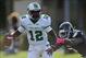 Oct 12, 2013; Boca Raton, FL, USA; Marshall Thundering Herd quarterback Rakeem Cato (12) slips away from Florida Atlantic Owls defense end Martin Wright (5) during the first quarter at FAU Football Stadium. Mandatory Credit: Steve Mitchell-USA TODAY Sport