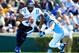 CHAPEL HILL, NC - NOVEMBER 30: Anthony Boone #7 of the Duke Blue Devils rolls ut under pressure from Jeff Schoettmer #34 of the North Carolina Tar Heels during play at Kenan Stadium on November 30, 2013 in Chapel Hill, North Carolina. (Photo by Grant Ha