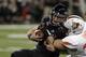 DETROIT, MI - DECEMBER 6: Quarterback Jordan Lynch #6 of the Northern Illinois Huskies is tackled by linebacker Paul Swan #33 of the Bowling Green Falcons during the first quarter of the MAC Championship at Ford Field on December 6, 2013 in Detroit, Michi