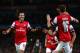 LONDON, ENGLAND - OCTOBER 01: Mesut Oezil #11of Arsenal is congratulated by teammate Aaron Ramsey #16 after scoring the opening goal during UEFA Champions League Group F match between Arsenal FC and SSC Napoli at Emirates Stadium on October 1, 2013 in L