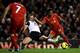 LIVERPOOL, ENGLAND - DECEMBER 4: Raheem Sterling of Liverpool shoots at goal under pressure from Ryan Bennett of Norwich City during the Barclays Premier League match between Liverpool and Norwich City at Anfield on December 4, 2013 in Liverpool, England