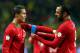 STOCKHOLM, SWEDEN - NOVEMBER 19: Huga Almeida helps Cristiano Ronaldo of Portugal with his captains bandage runs with the ball during the FIFA 2014 World Cup Qualifier Play-off Second Leg match between Sweden and Portugal at Friends Arena on November 19,