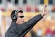 AMES, IA - OCTOBER 26: Head coach Mike Gundy of the Oklahoma State Cowboys signals a play from the sidelines during the second half of play against the Iowa State Cyclones at Jack Trice Stadium on October 26, 2013 in Ames, Iowa. The Oklahoma State Cowboys