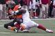 Dec 7, 2013; Stillwater, OK, USA; Oklahoma State Cowboys quarterback Clint Chelf (10) is tackled by Oklahoma Sooners defensive end Charles Tapper (91) during the fourth quarter at Boone Pickens Stadium. Mandatory Credit: Richard Rowe-USA TODAY Sports