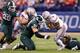 INDIANAPOLIS, IN - DECEMBER 07: Quarterback Braxton Miller #5 of the Ohio State Buckeyes is tackled by Tyler Hoover#91 and Denicos Allen #28 of the Michigan State Spartans during the Big Ten Conference Championship game at Lucas Oil Stadium on December