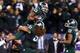 INDIANAPOLIS, IN - DECEMBER 07: Jeremy Langford #33 of the Michigan State Spartans is lifted by teammate Fou Fonoti #51 after scoring the game winning touchdown in the fourth quarterof the Big Ten Conference Championship game against the Ohio State Bucke