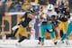 PITTSBURGH, PA - DECEMBER 08: Lamar Miller #26 of the Miami Dolphins fights for more yards as Will Allen #20 of the Pittsburgh Steelers wraps him up and teammate Troy Polamalu #43 moves in to help during the second quarter at Heinz Field on December 8, 20
